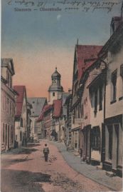 Hier geht es zur Karte mit dem Motiv 'Gepflasterte Straße und Geschäfte' Hier geht es zur Karte mit dem Motiv 'Gepflasterte Straße und Geschäfte'